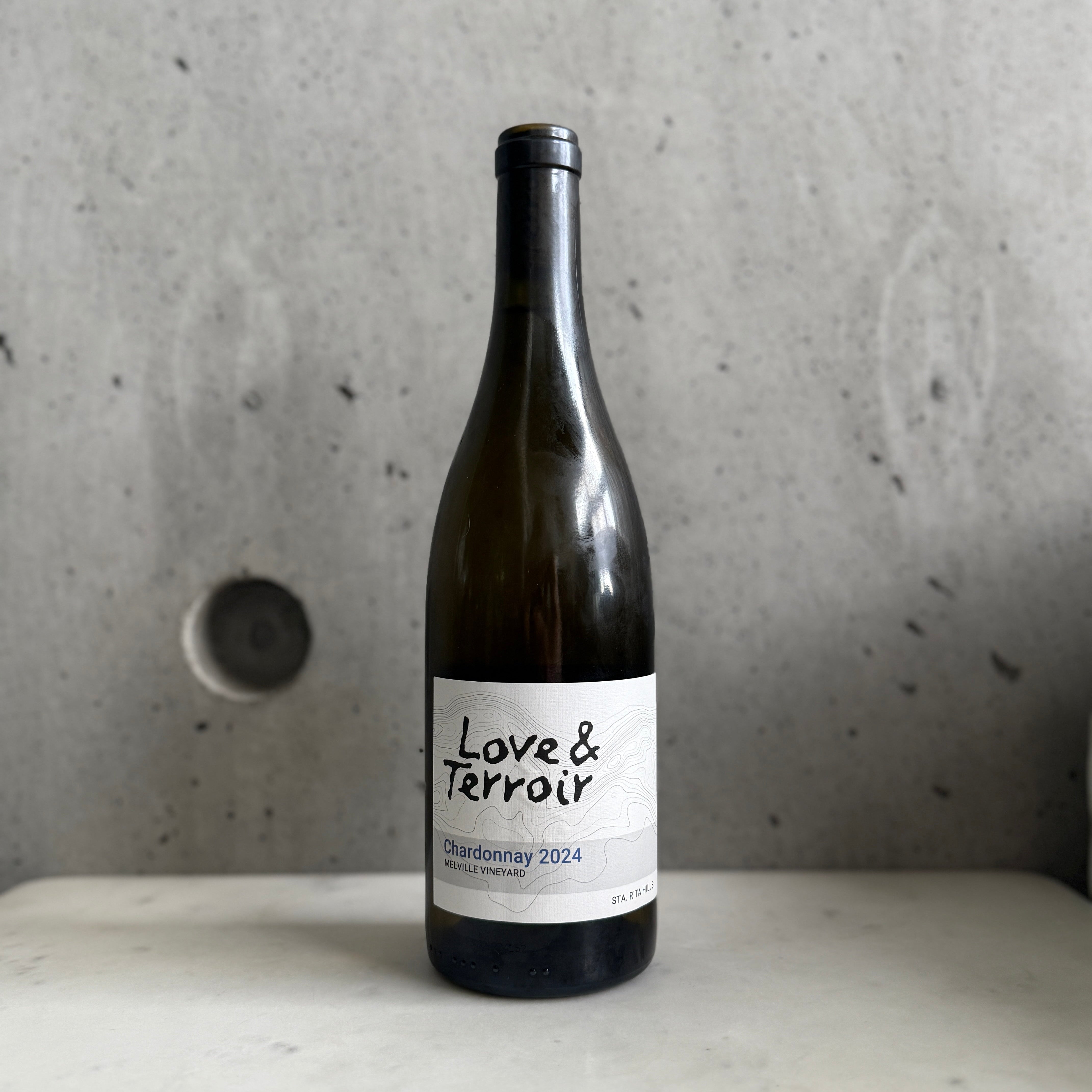 2024 Love & Terroir Chardonnay on a concrete surface